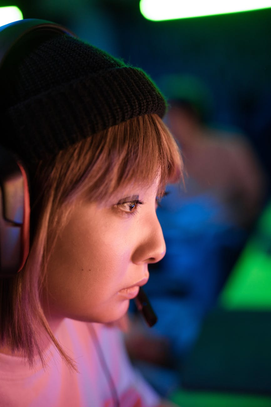 woman in black knit cap wearing headset